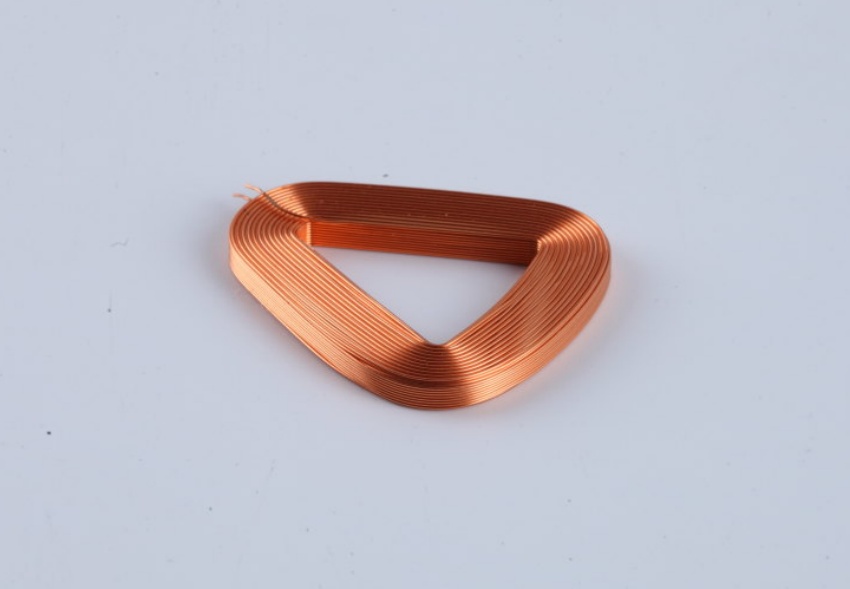 Engineer testing an odd-shaped coil with an LCR meter