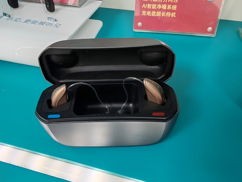 A hearing aid resting in its wireless charging case
